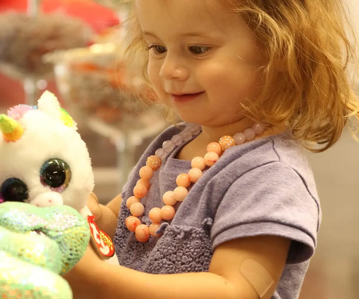 Girl holding TY beanie baby