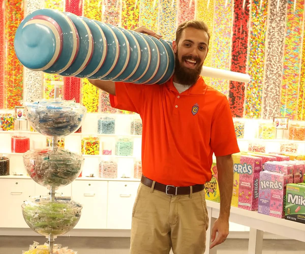 Man holding giant lollipop