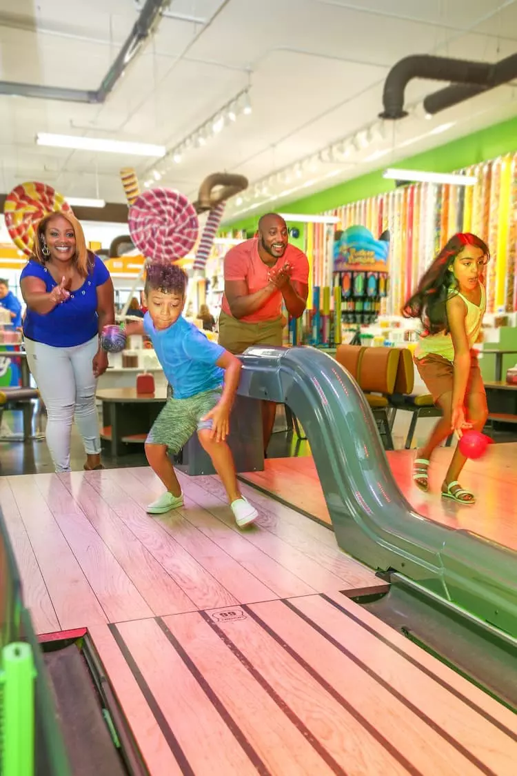 family playing mini bowling