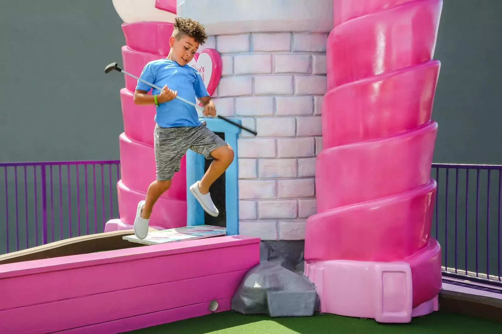 boy playing putt putt